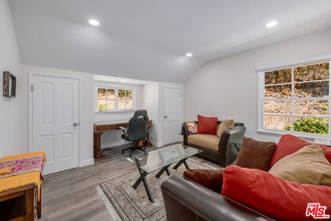 2841 Roscomare Road Los Angeles, CA 90077 - Photo 16 of 28 a living room with furniture and a window