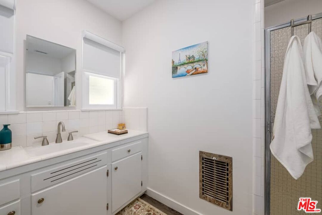 2841 Roscomare Road Los Angeles, CA 90077 - Photo 17 of 28 a bathroom with a sink and a mirror