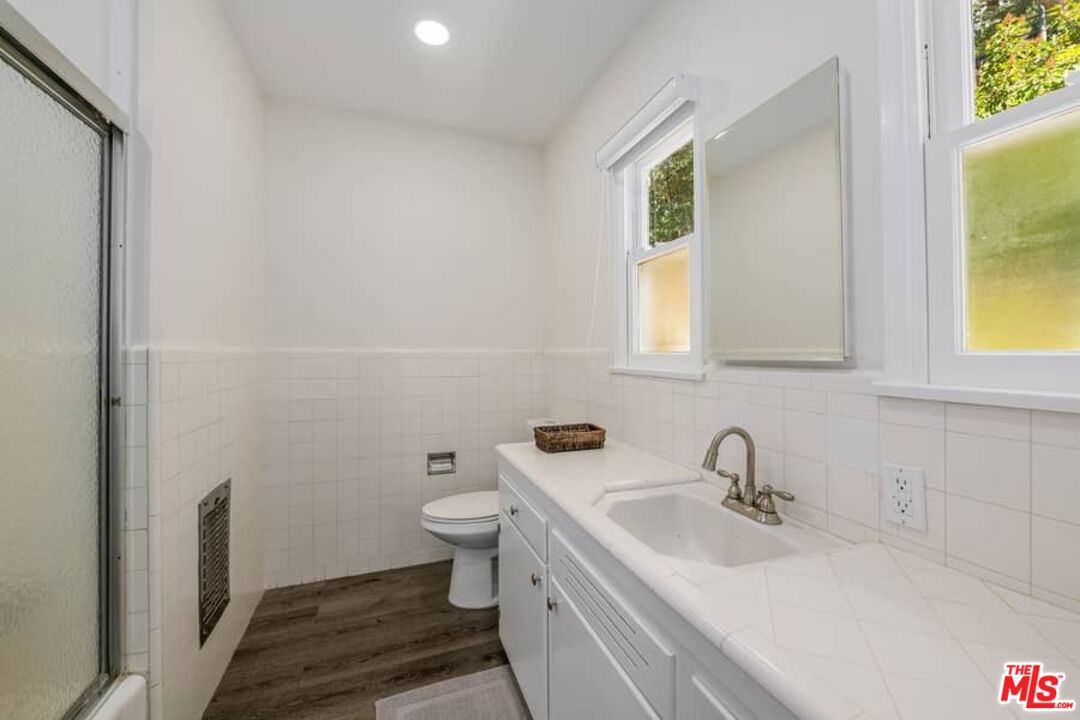2841 Roscomare Road Los Angeles, CA 90077 - Photo 20 of 28 a bathroom with a sink and a mirror