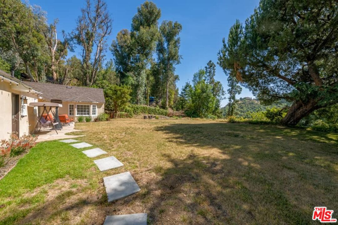 2841 Roscomare Road Los Angeles, CA 90077 - Photo 21 of 28 a front view of a house with a yard