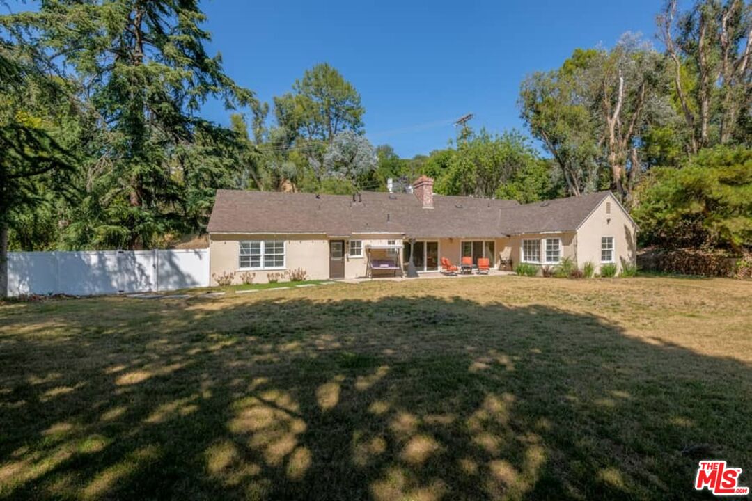 2841 Roscomare Road Los Angeles, CA 90077 - Photo 23 of 28 a front view of a house with a garden