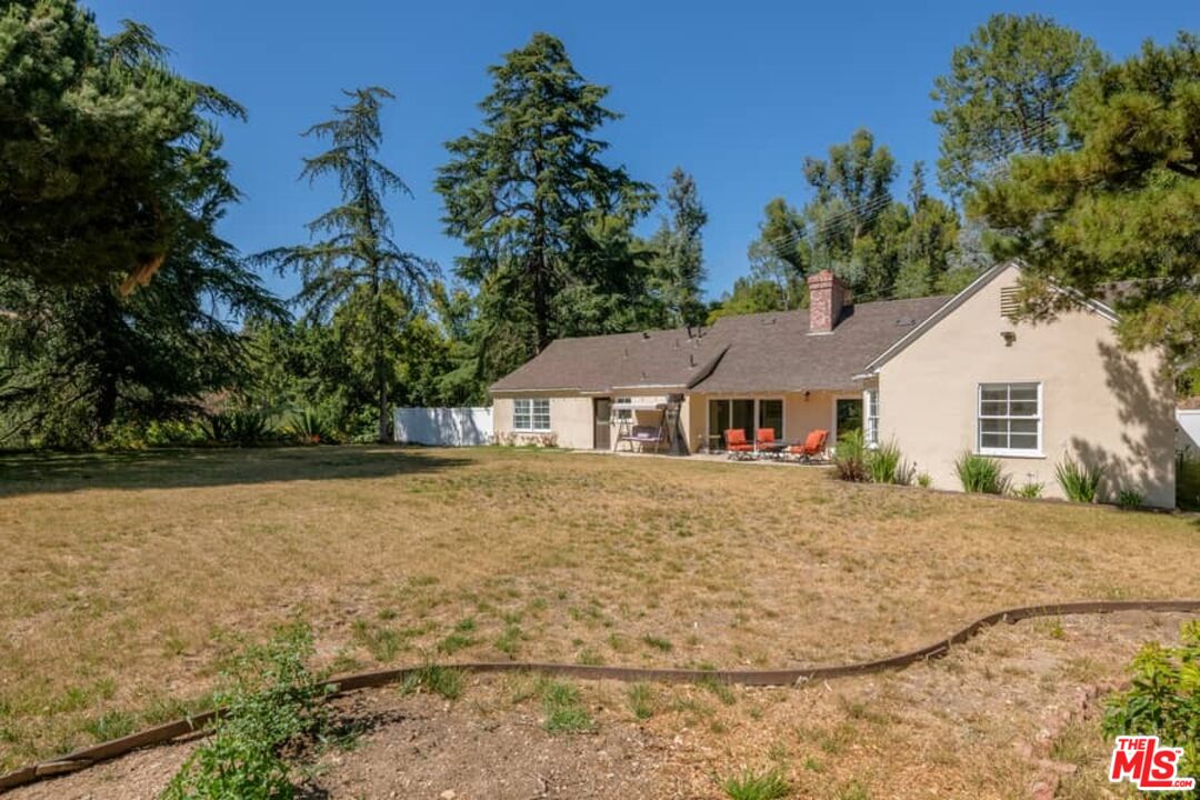 2841 Roscomare Road Los Angeles, CA 90077 - Photo 25 of 28 a front view of a house with a yard