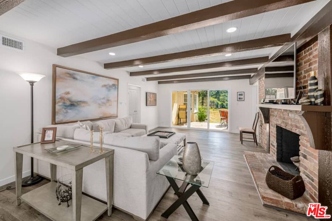 2841 Roscomare Road Los Angeles, CA 90077 - Photo 5 of 28 a view of a dining room with furniture window and wooden floor