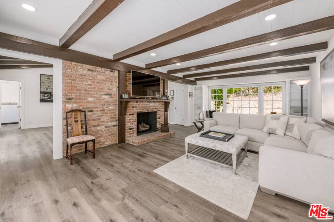 2841 Roscomare Road Los Angeles, CA 90077 - Photo 6 of 28 a living room with furniture and a fireplace