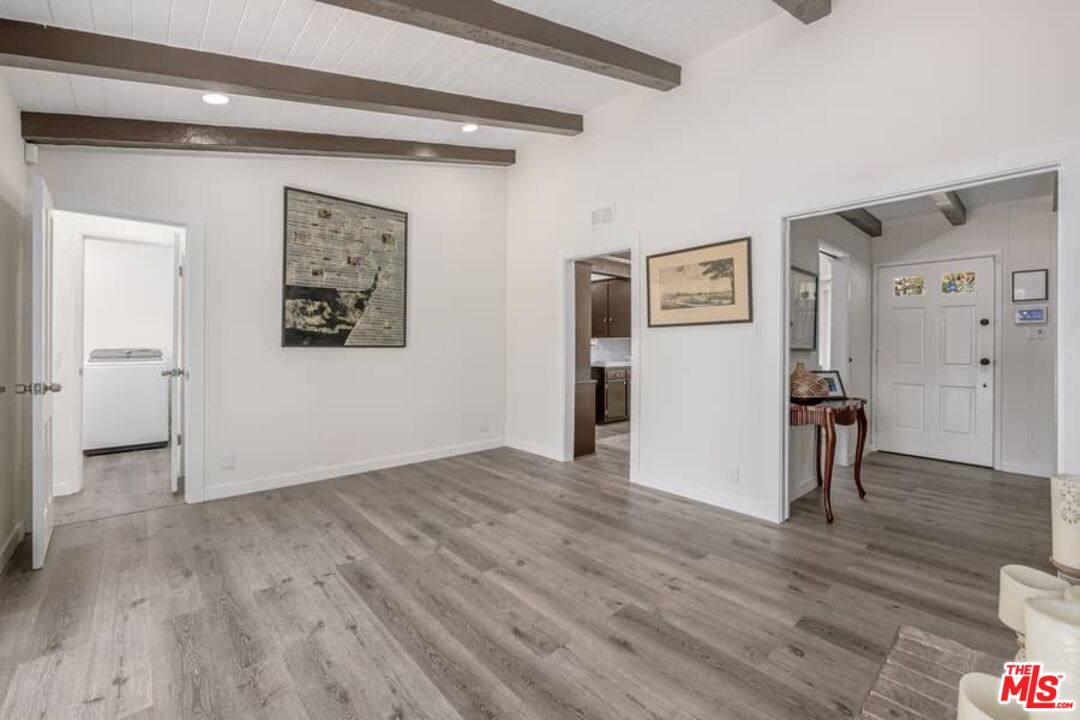 2841 Roscomare Road Los Angeles, CA 90077 - Photo 7 of 28 a view of empty room with wooden floor
