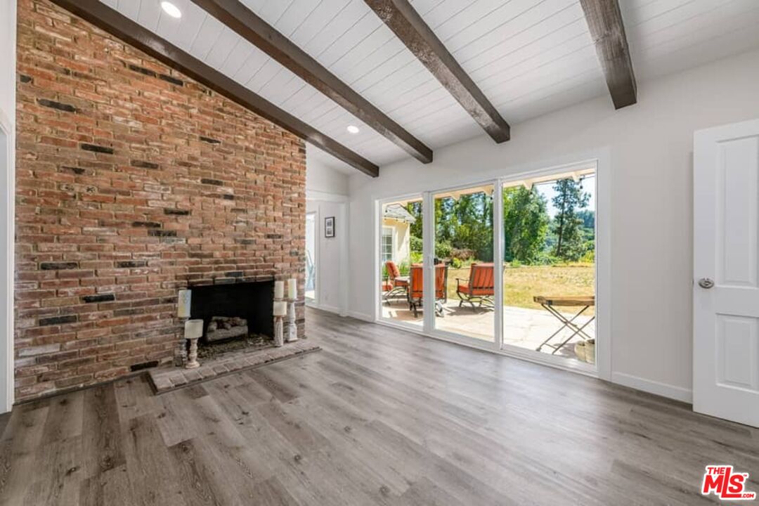 2841 Roscomare Road Los Angeles, CA 90077 - Photo 8 of 28 wooden floor fireplace and natural light in room