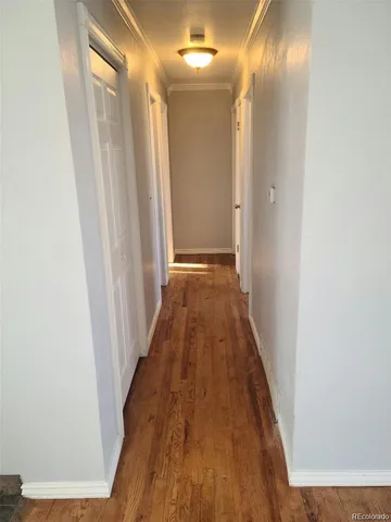 a view of a hallway with wooden floor