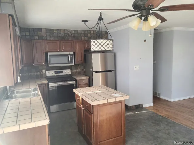 a kitchen with a refrigerator and a sink