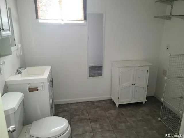 a white toilet sitting next to a bathroom sink