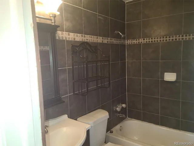 a bathroom with a toilet and bathtub