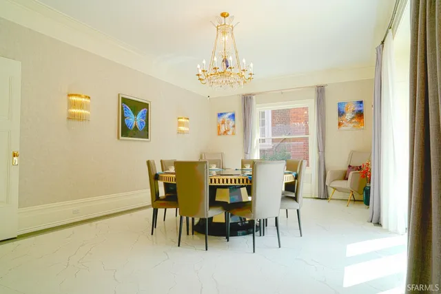 a view of a dining room with furniture and a chandelier