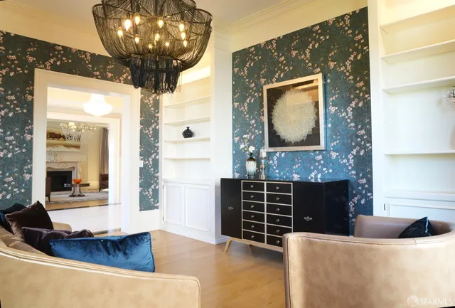 a living room with fireplace furniture and a large window