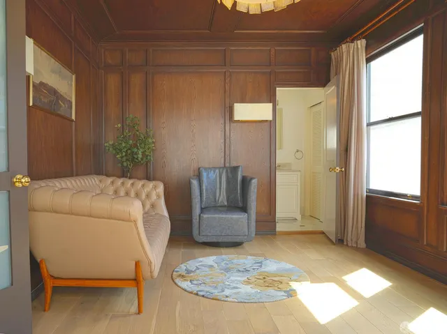 a bedroom with a large bed and a dresser