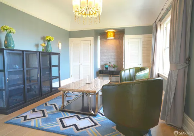 a bedroom with two beds and a chandelier