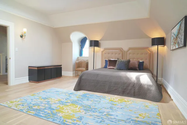 a bedroom with furniture and a window