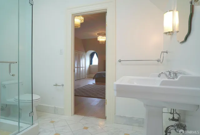 a bathroom with a sink toilet and shower