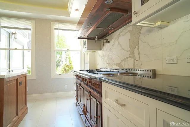 a kitchen with a stove and a white cabinet