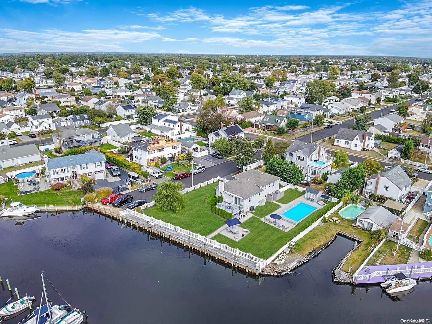 215 West Santa Barbara Road Lindenhurst, NY 11757 - Photo 1 of 1 an aerial view of residential houses with outdoor space