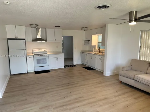 a kitchen with granite countertop a stove and a refrigerator