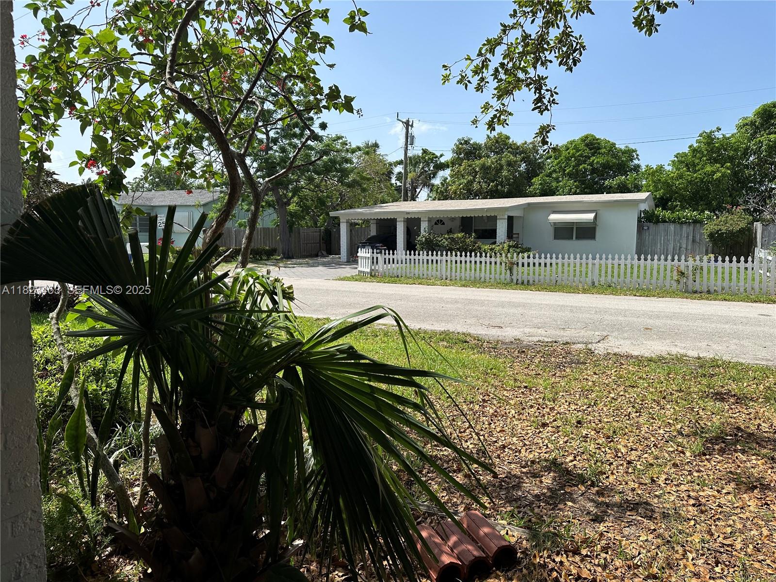 201 East 28th Street Riviera Beach, FL 33404 - Photo 17 of 27 a view of a house with a yard