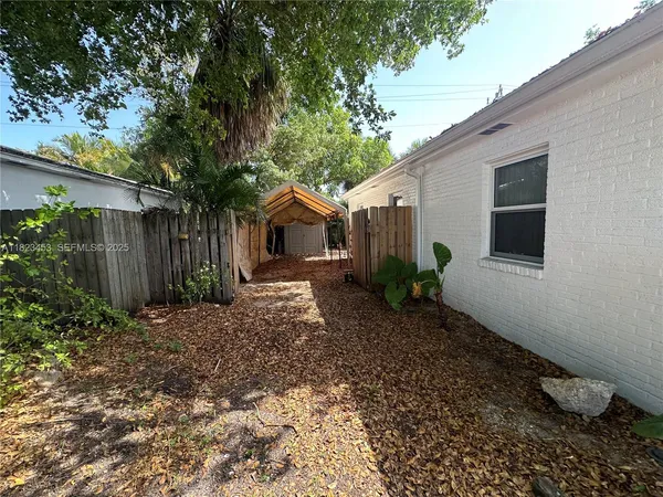 a backyard of a house with plants and trees
