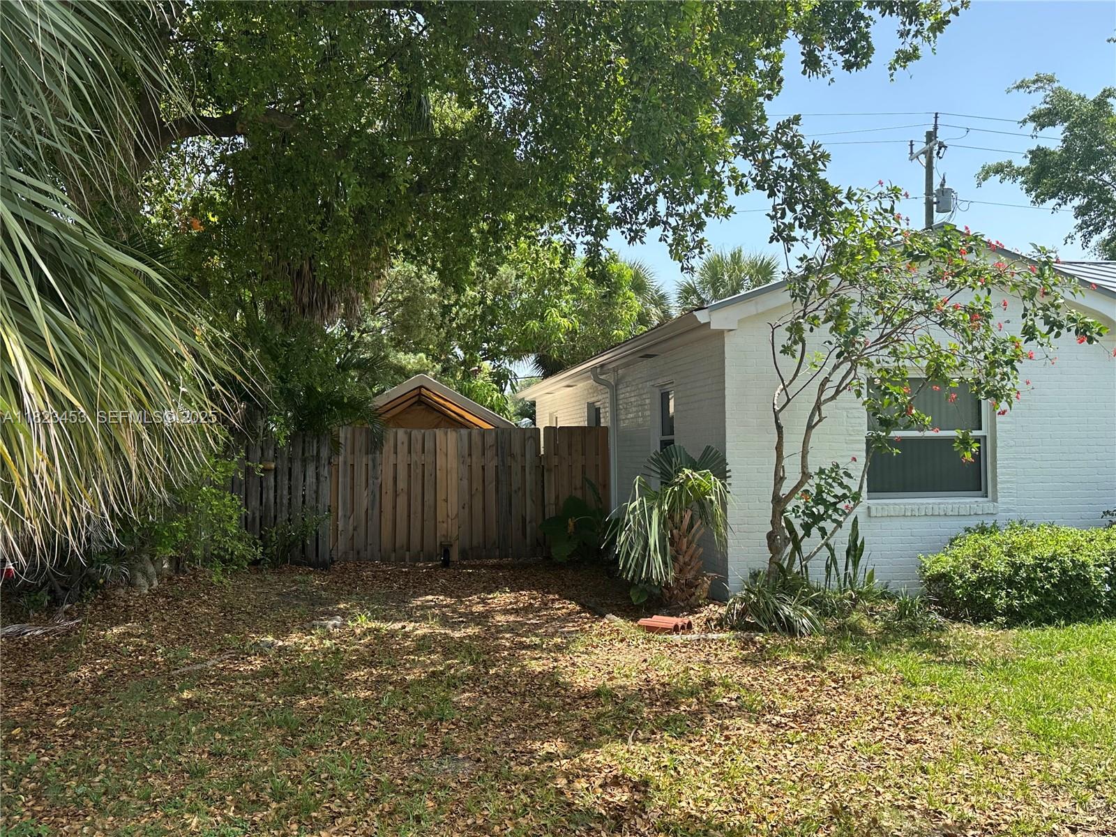 201 East 28th Street Riviera Beach, FL 33404 - Photo 23 of 27 a front view of a house with garden