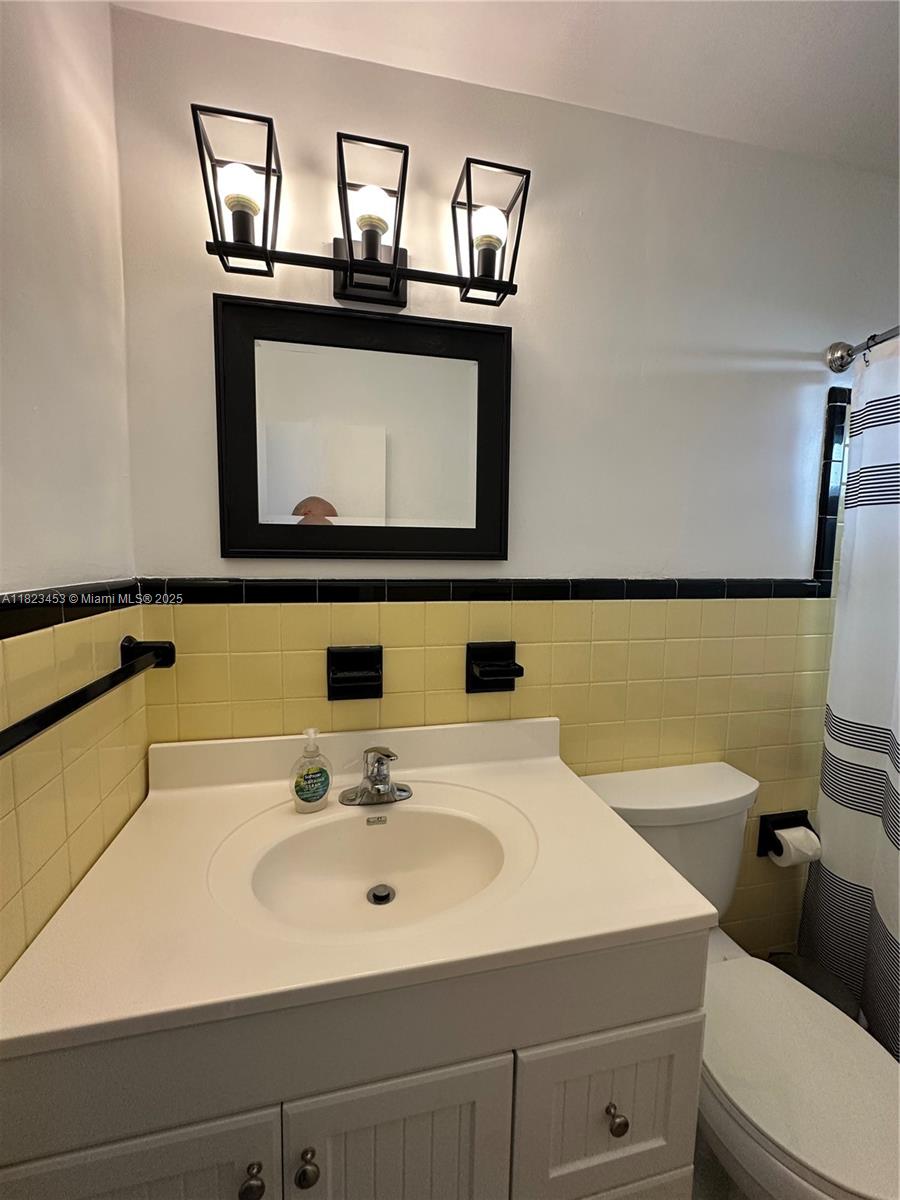 201 East 28th Street Riviera Beach, FL 33404 - Photo 5 of 27 a bathroom with a sink and a mirror