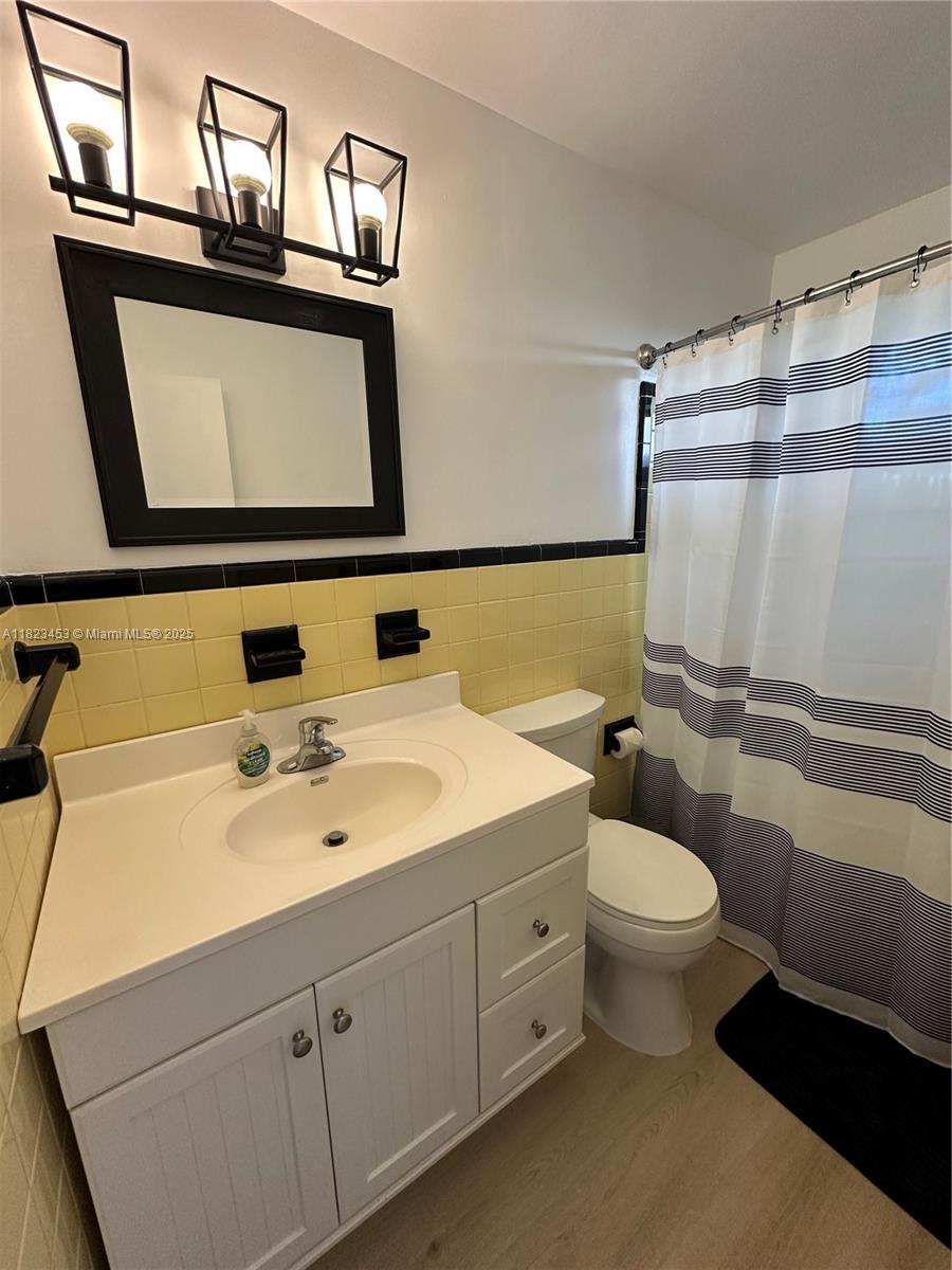 201 East 28th Street Riviera Beach, FL 33404 - Photo 7 of 27 a bathroom with a toilet sink and mirror