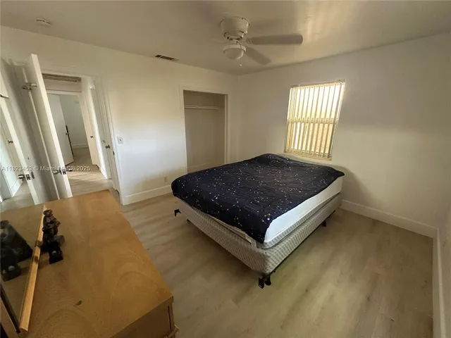 a bed sitting in a room next to a window