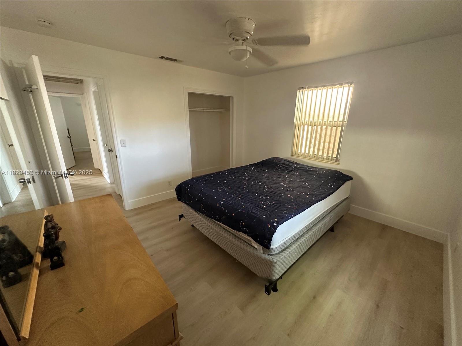 201 East 28th Street Riviera Beach, FL 33404 - Photo 8 of 27 a bed sitting in a room next to a window