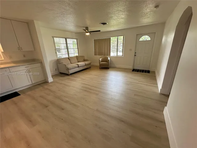 a view of a livingroom with furniture and wooden floor