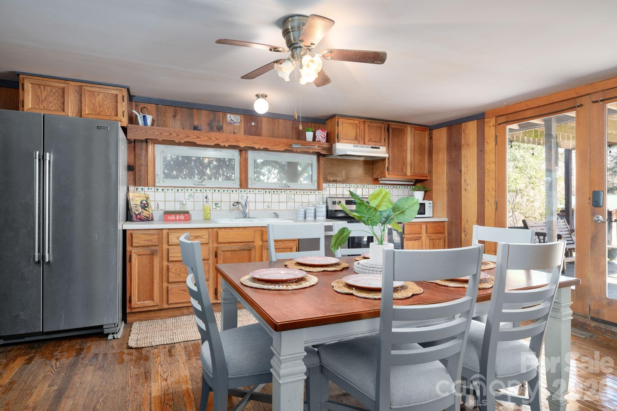 1265 Dillingham Road Barnardsville, NC 28709 - Photo 11 of 46 a dining room with furniture a window and wooden floor