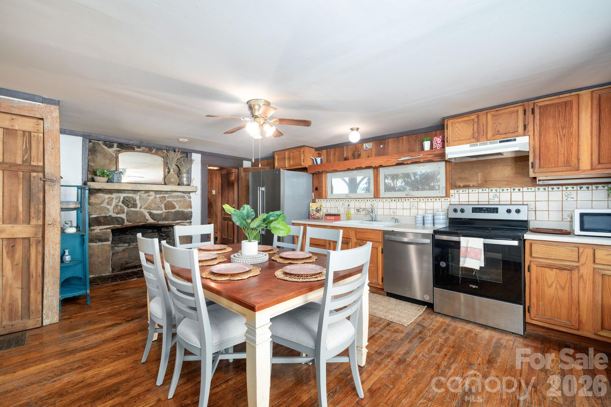 1265 Dillingham Road Barnardsville, NC 28709 - Photo 13 of 46 a view of a dining room with furniture and wooden floor