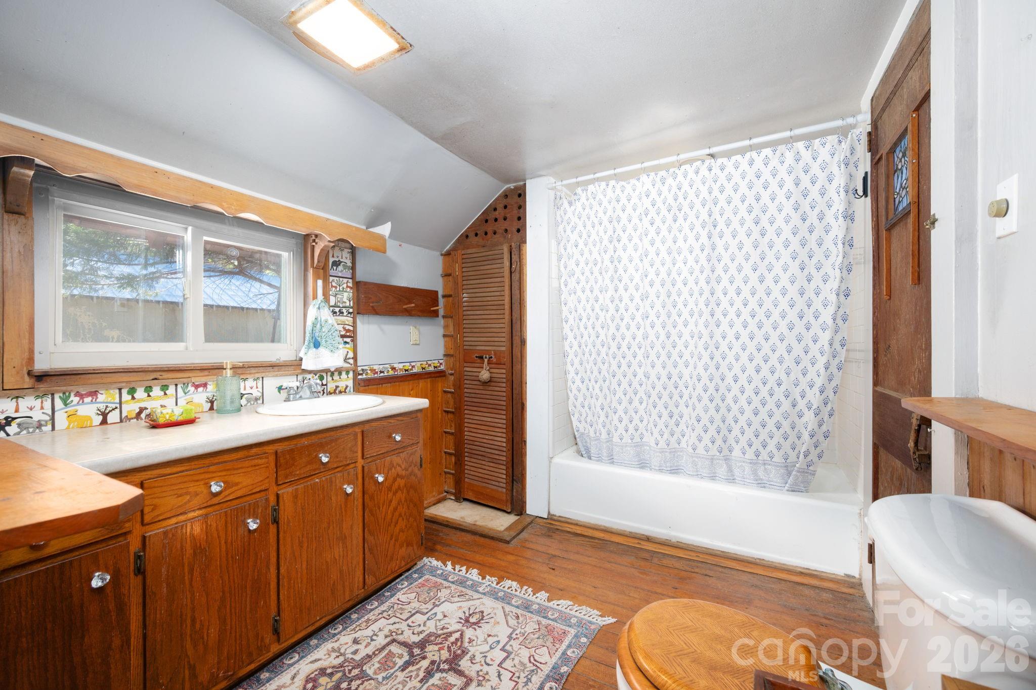 1265 Dillingham Road Barnardsville, NC 28709 - Photo 17 of 46 a spacious bathroom with a double vanity sink a mirror and a shower