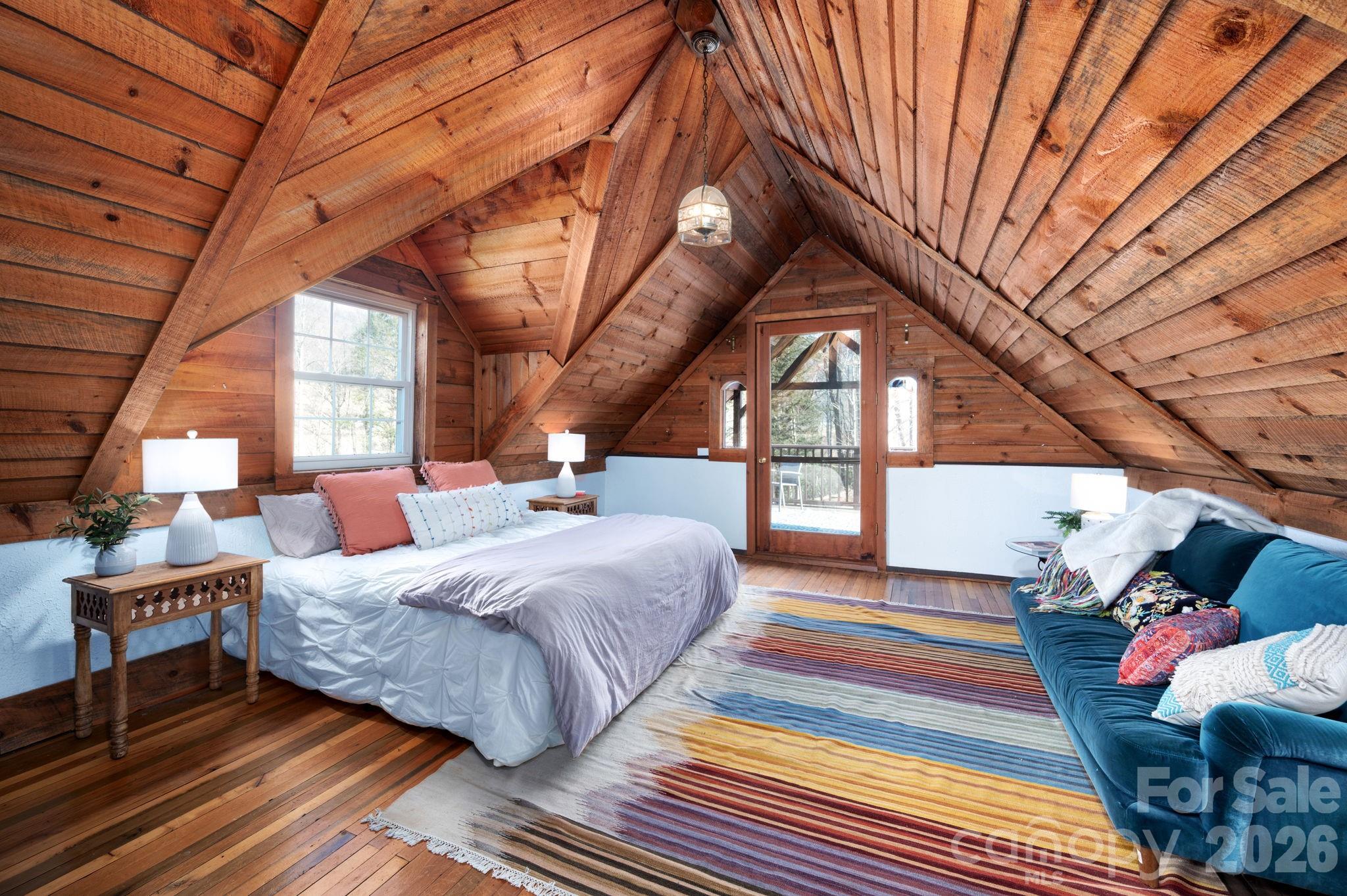 1265 Dillingham Road Barnardsville, NC 28709 - Photo 25 of 46 a bedroom with a bed and a large window