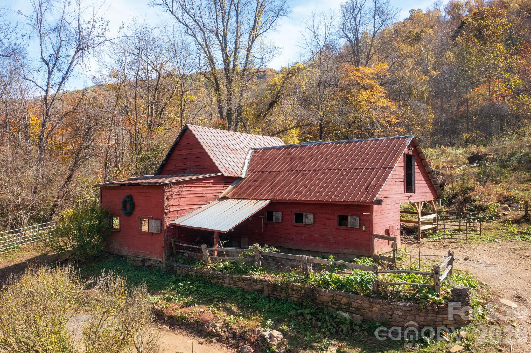 1265 Dillingham Road Barnardsville, NC 28709 - Photo 30 of 46 a view of a house with a yard plants and large tree
