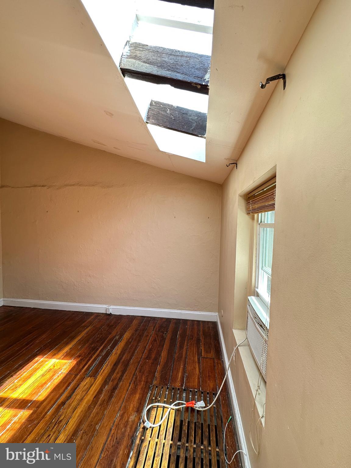 623 South American Street, Unit F Philadelphia, PA 19147 - Photo 21 of 38 a view of an empty room with wooden floor and a window