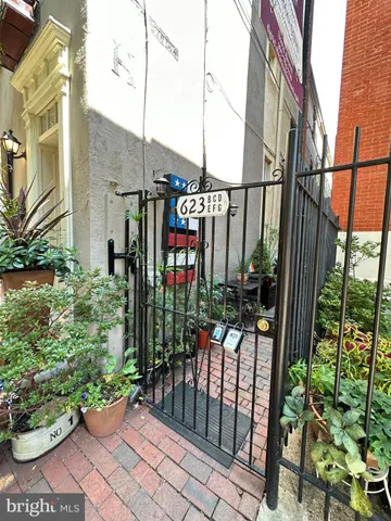 a view of empty room with wooden floor and fireplace