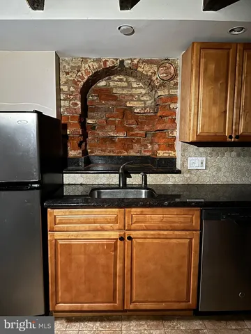 a stove top oven sitting inside of a kitchen