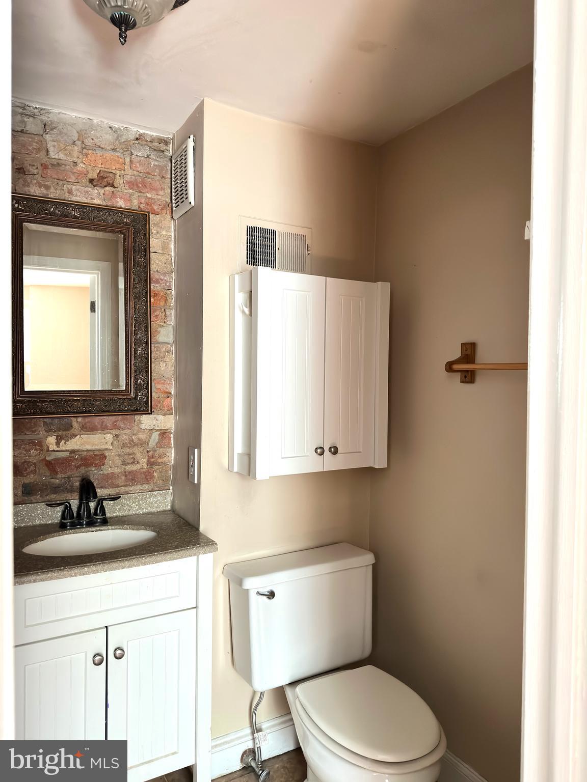 623 South American Street, Unit F Philadelphia, PA 19147 - Photo 7 of 38 a bathroom with a toilet a sink and a mirror