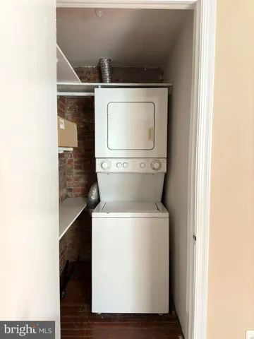 a view of a room with wooden floor and windows