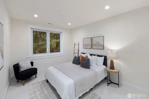 a bedroom with a bed and a couch