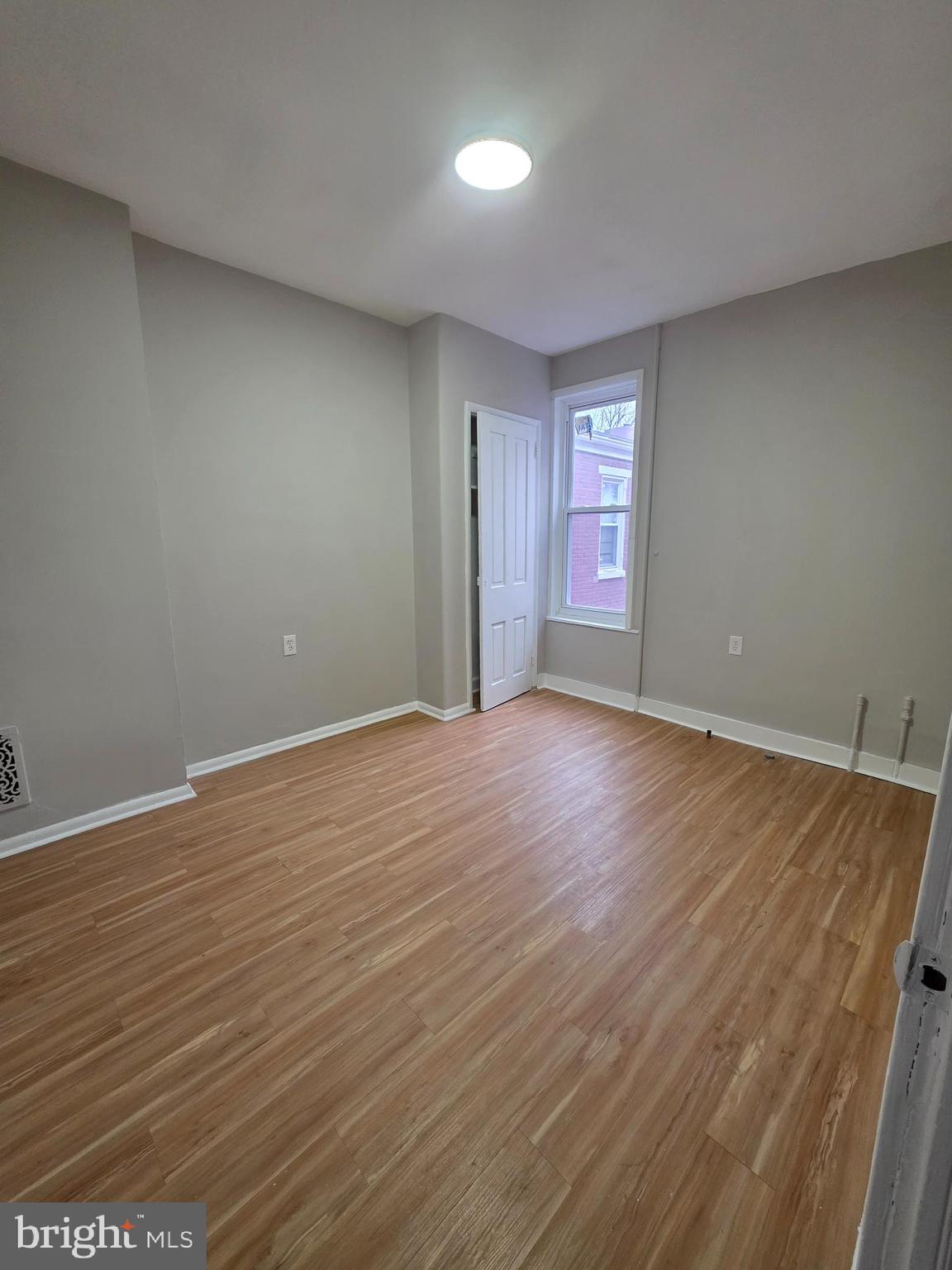 202 South 6th Street Reading, PA 19602 - Photo 8 of 11 a view of an empty room with wooden floor and a window