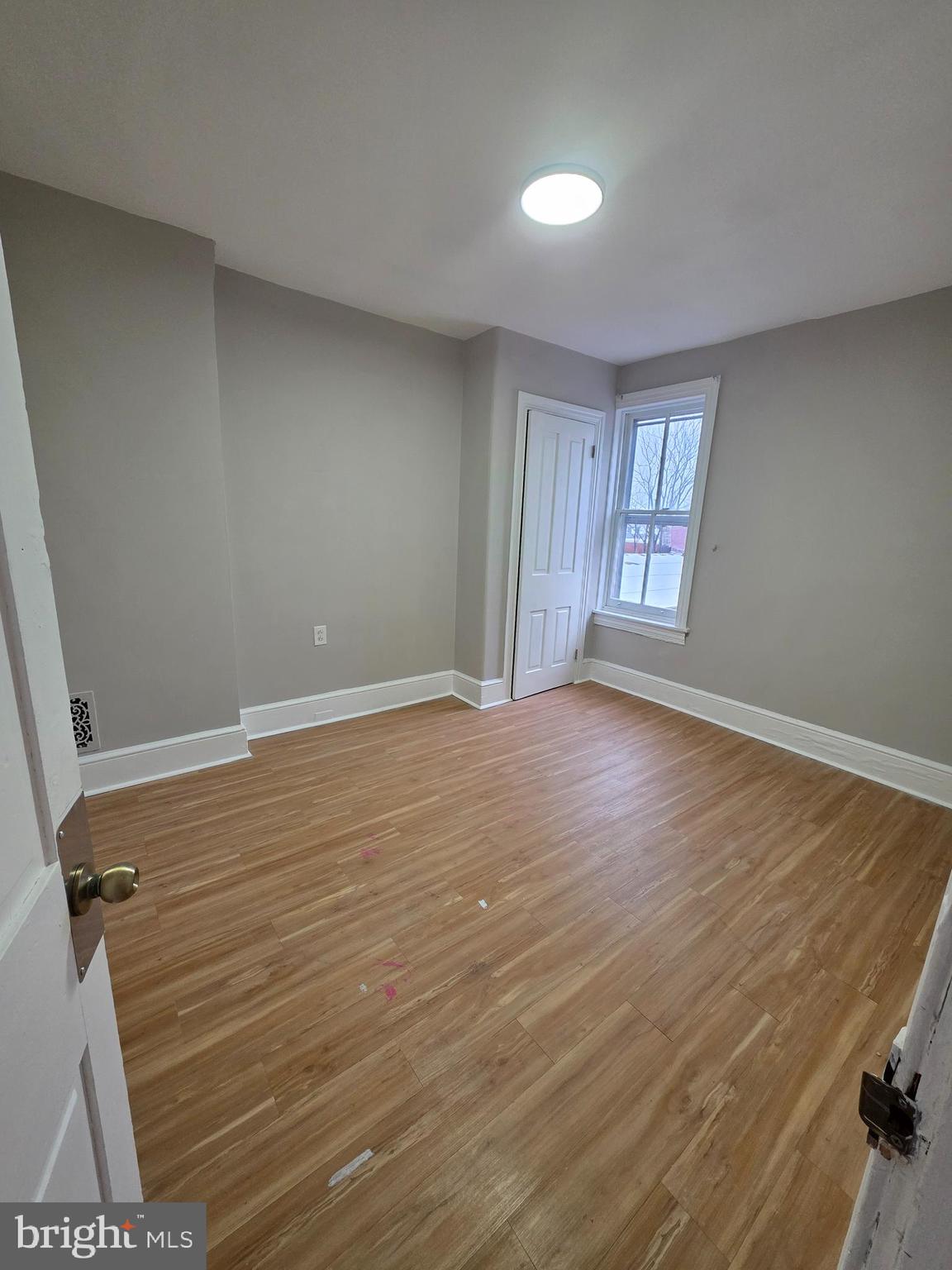 202 South 6th Street Reading, PA 19602 - Photo 10 of 11 wooden floor in an empty room with a window