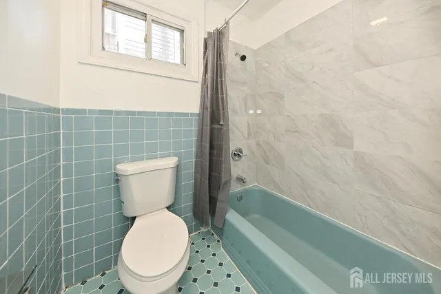 a bathroom with a toilet and a bathtub