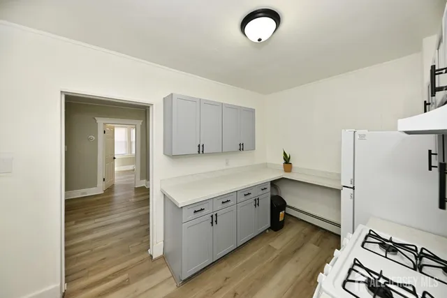 a view of a kitchen with sink and wooden floor