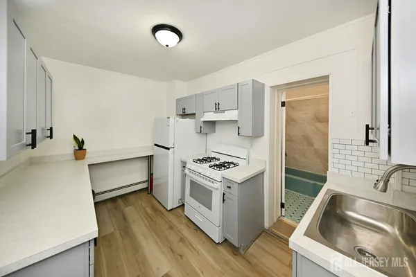 a kitchen that has a sink and a stove