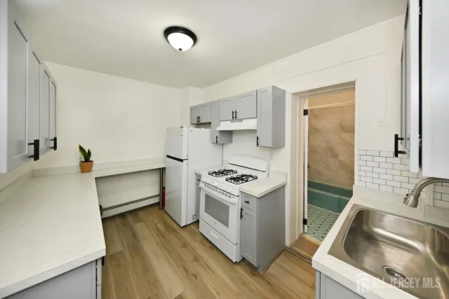 a kitchen that has a sink and a stove