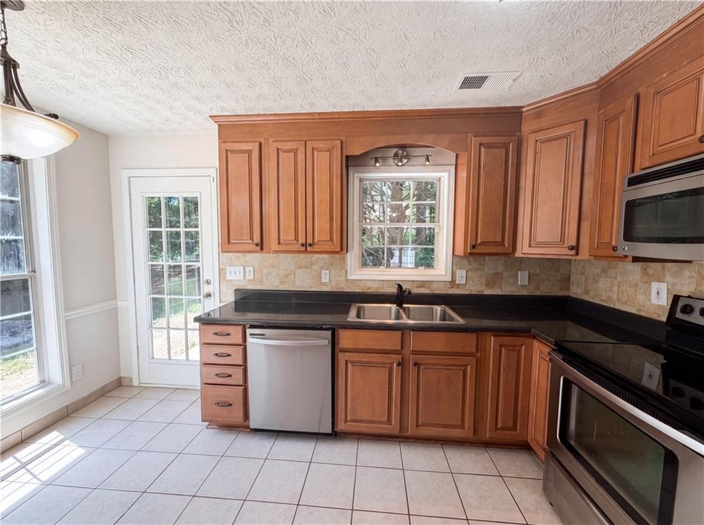722 Ridgetop Road Bethlehem, GA 30620 - Photo 8 of 23 a kitchen with stainless steel appliances granite countertop a stove a sink and a microwave