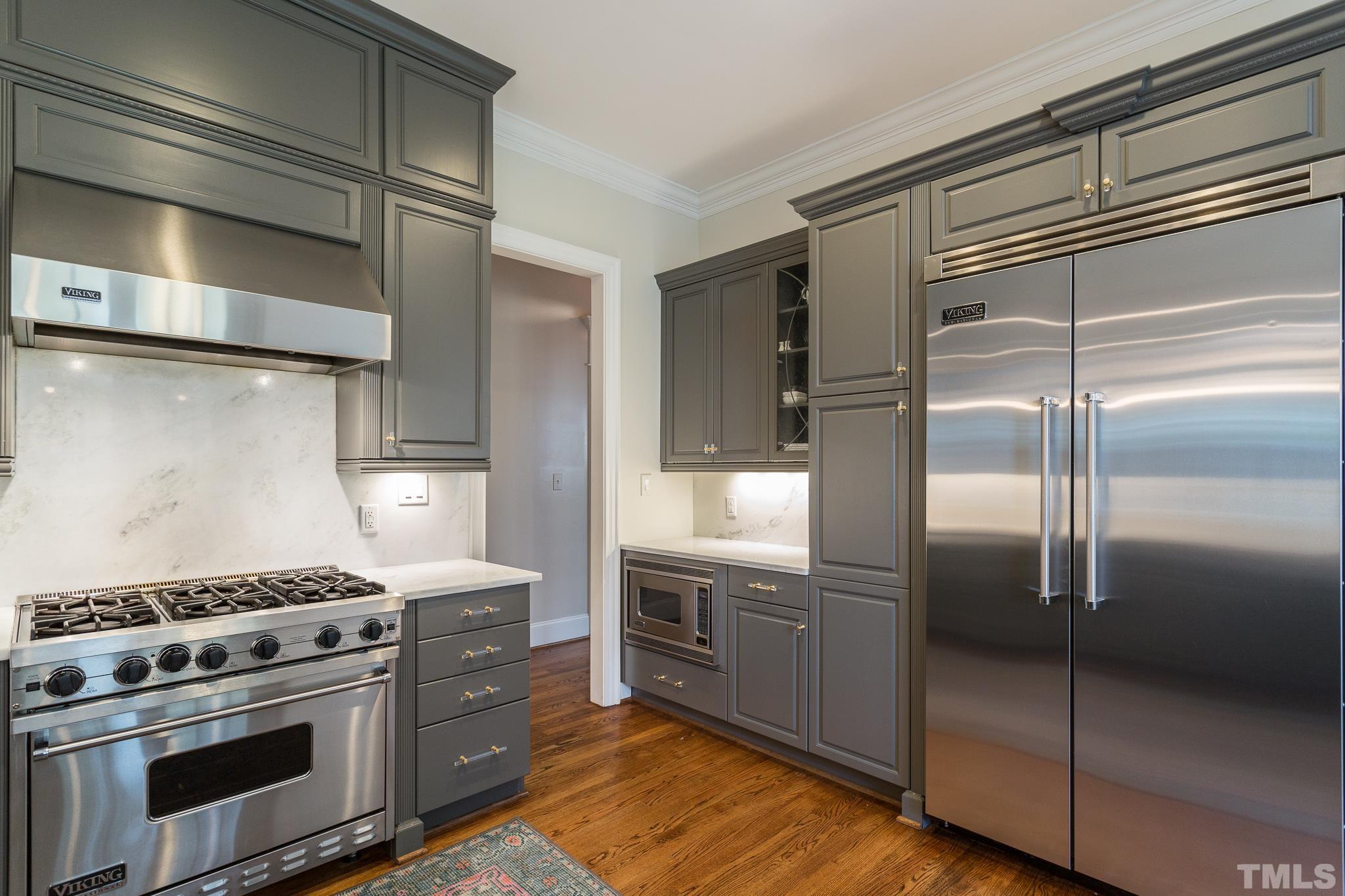 2505 Anderson Drive Raleigh, NC 27608 - Photo 11 of 30 a kitchen with cabinets and stainless steel appliances